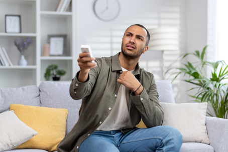 man feeling the heat at home